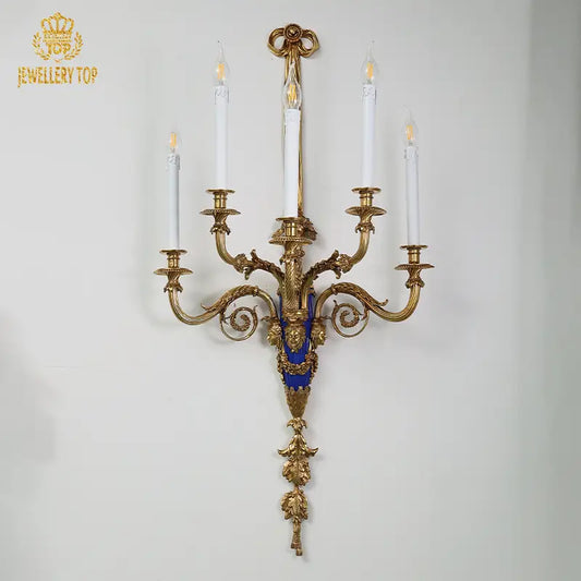 Close-up of rococo carvings on bronze wall light