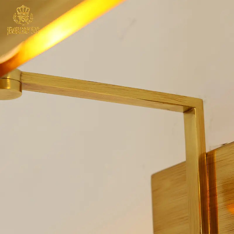 Luxury brass wall lamp with brand insignia detail