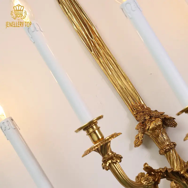 Five-arm vintage sconce illuminating white textured wall