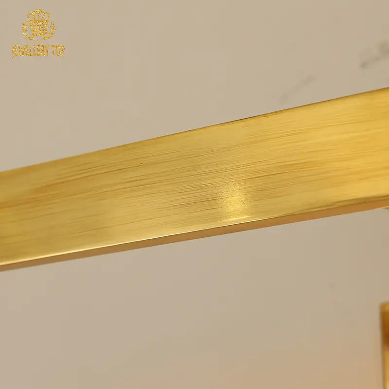 Luxury brass wall lamp with brand insignia detail