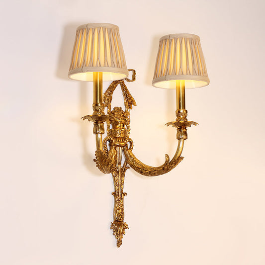 Side angle showing ornate leaf motifs and gently curved brass arms