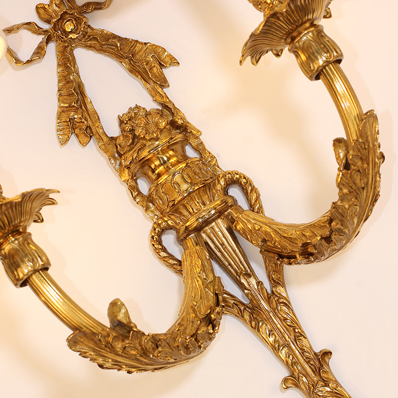 Close-up highlighting the sculpted bow detail at the top of the brass fixture