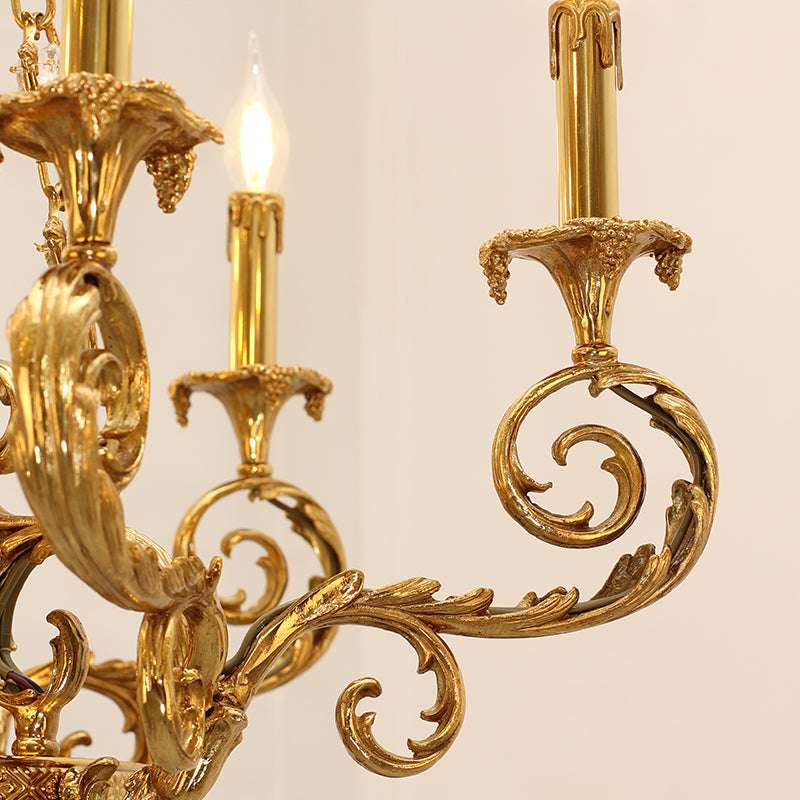 Close-up of ornate botanical motifs on the Aurelian brass chandelier.