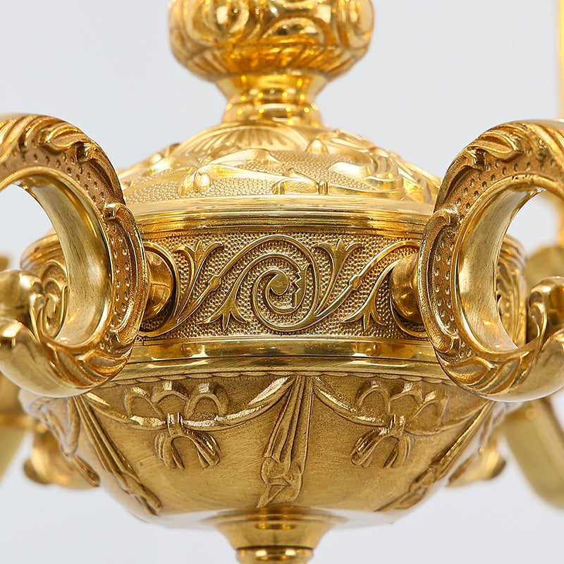 Refined brass detailing on a timeless chandelier showcasing intricate carvings.
