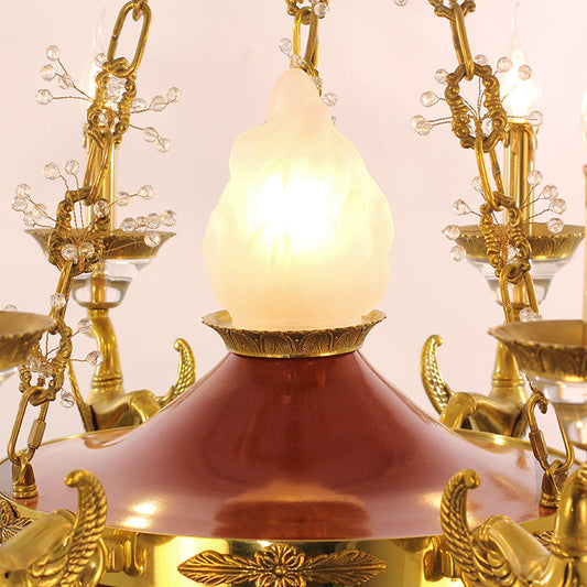 Close-up of the central flame-inspired glass shade of the vintage lamp.