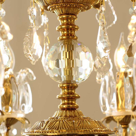 Intricately designed crystal sphere centerpiece of vintage brass chandelier.