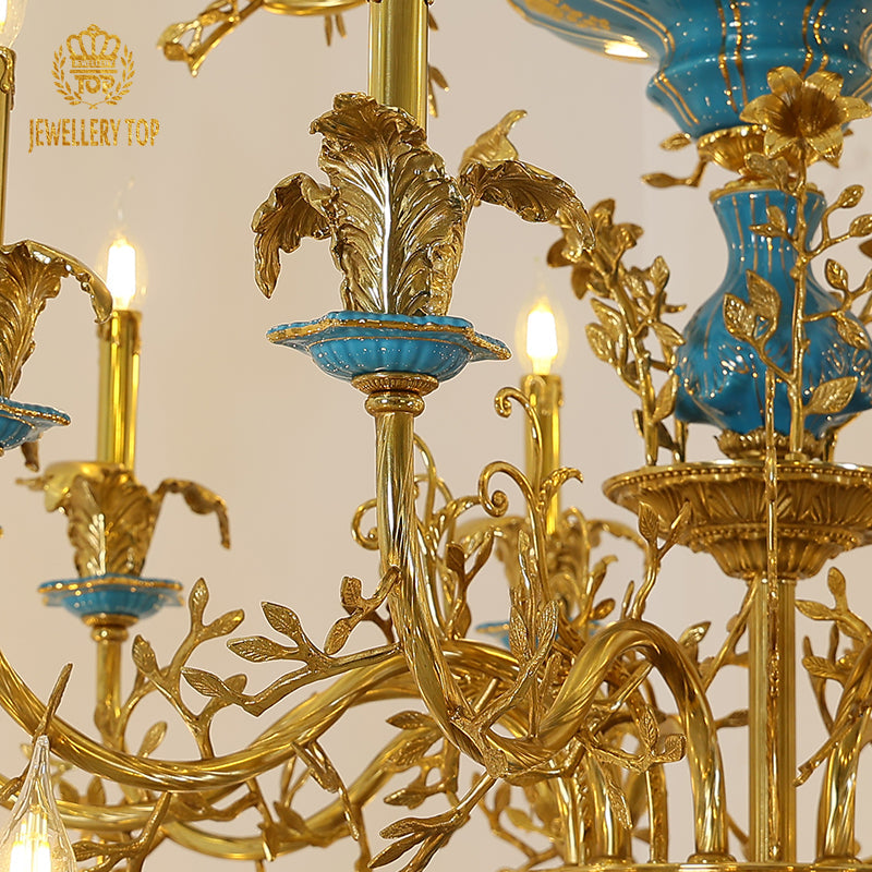 Brass candle-style arms gracefully curving from the azure ceramic chandelier body.