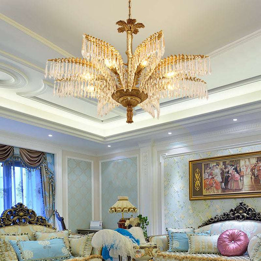 Luxurious tropical chandelier featuring brass palm fronds and radiant crystal accents.