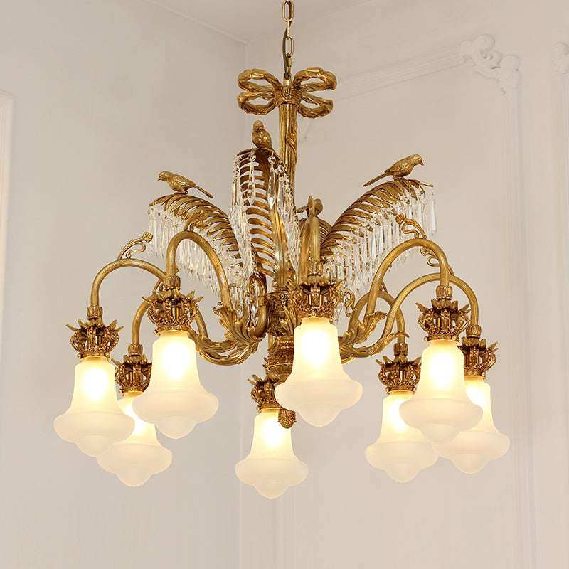 Vintage chandelier featuring frosted glass shades and brass detailing