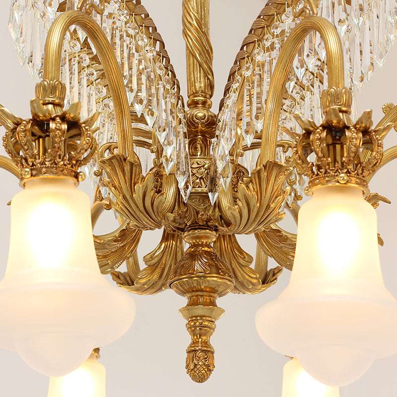 Close-up of brass chandelier arms with crystal pendants
