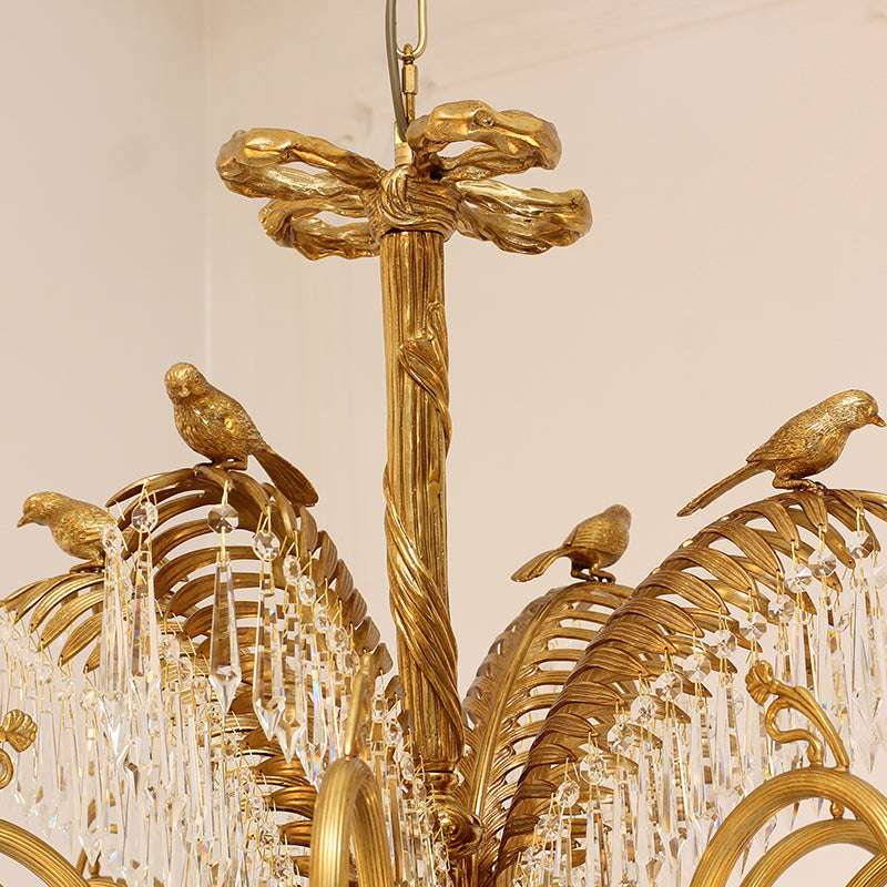 Detail of brass birds and crystal decoration on vintage chandelier