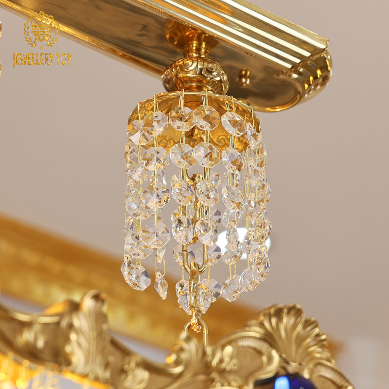 Close‑up of hand‑cut crystal beads hanging from a luxury brass chandelier.