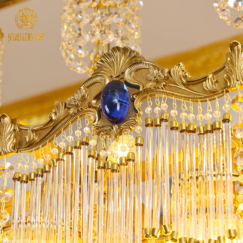 Ornate fleur‑de‑lis brass detailing on a vintage french chandelie
