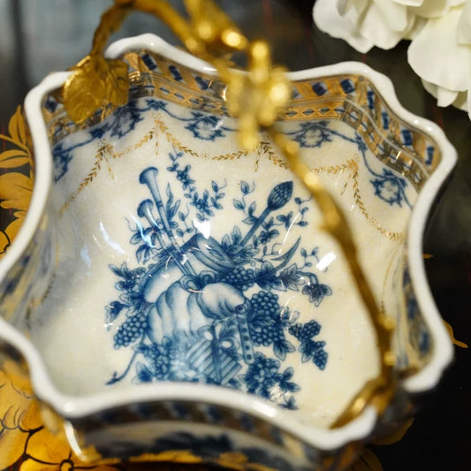 French-style fruit basket featuring brass handles and white ceramic interior