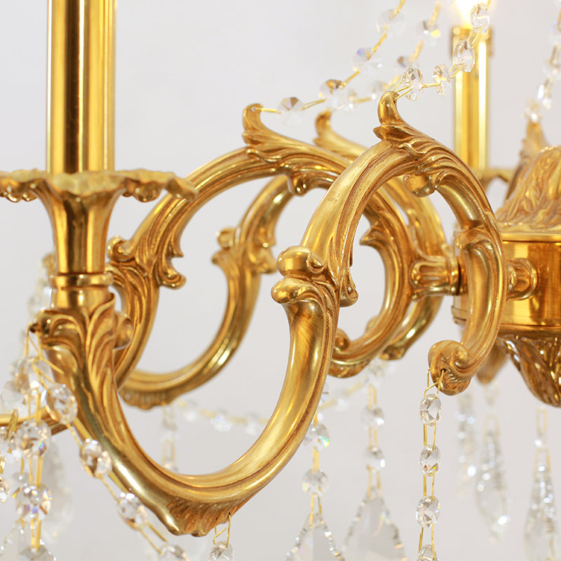 Close-up of polished bronze loops and intricate detailing on a classic light fixture.