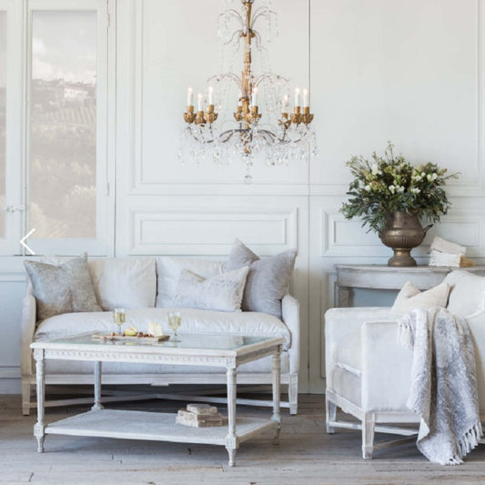 Candle-style Edison bulbs and frosted glass shades casting warm amber light