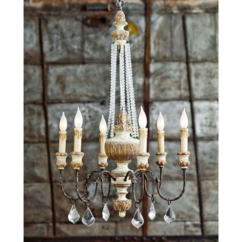 Country chandelier with weathered bronze arms and oak medallion in a rustic kitchen