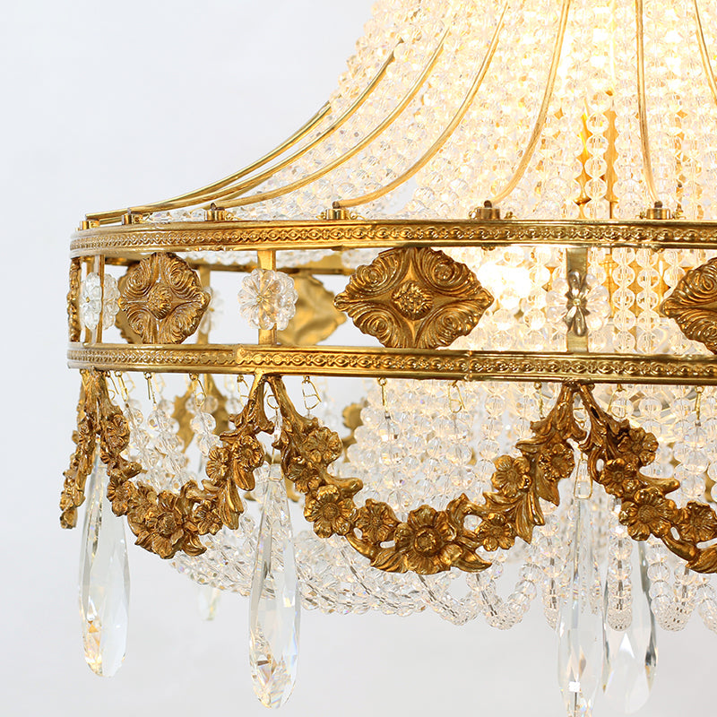 Close-up of brass and crystal details on the gold pendant lamp