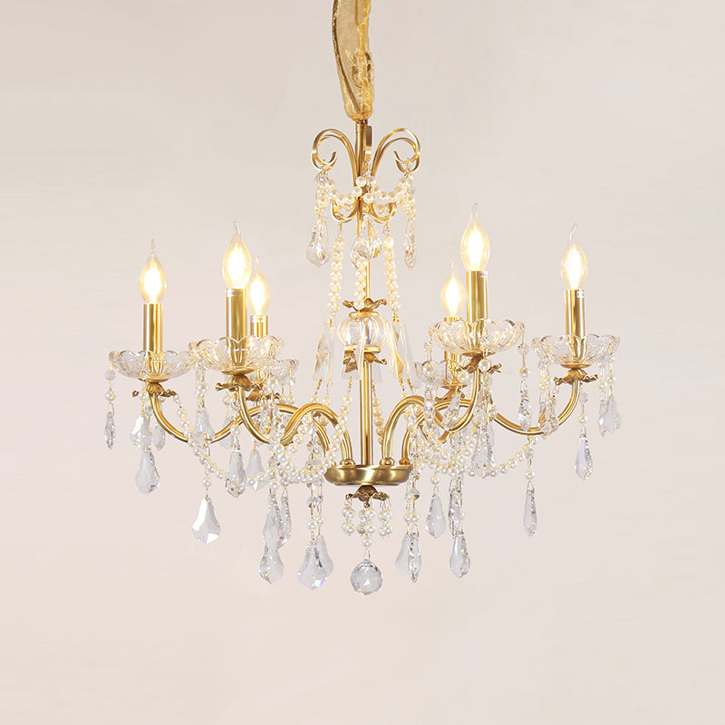 Polished brass arms elegantly curving to support candle-style bulbs.