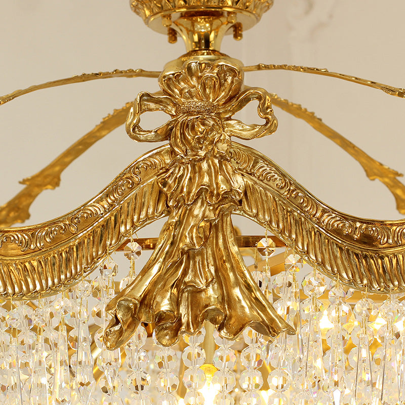 Detailed view of vintage ceiling lights showcasing golden brass bow and crystal beads.
