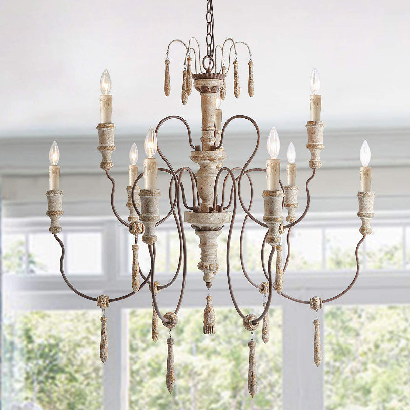 Rustic chandelier with grapevine-inspired arms and wooden pendants in a farmhouse dining room