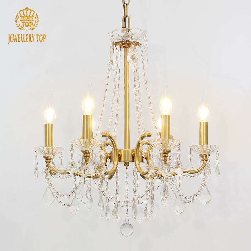 Vintage French chandelier featuring brass arms and crystal accents.