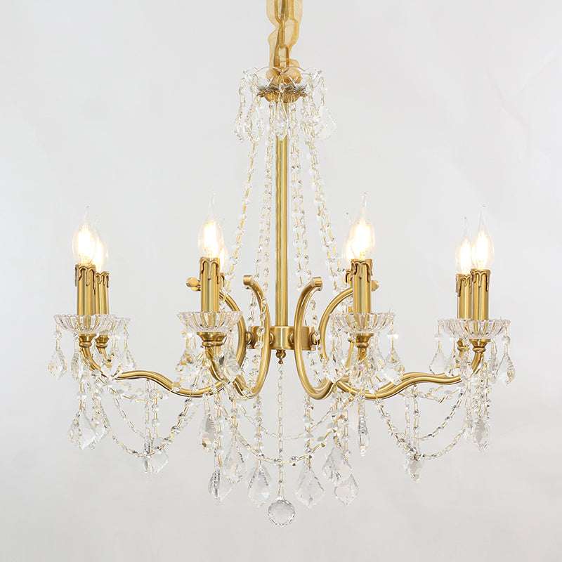 Elegant crystal beads reflecting warm light from a luxury lighting fixture.