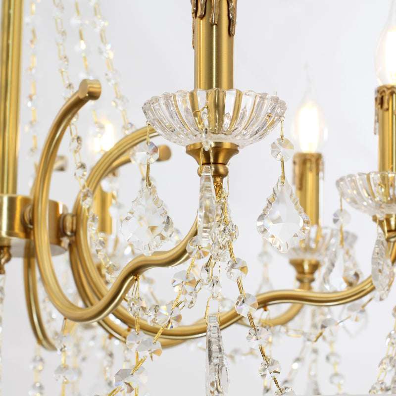 Close-up of brass candle-style holders with cascading crystal chains.