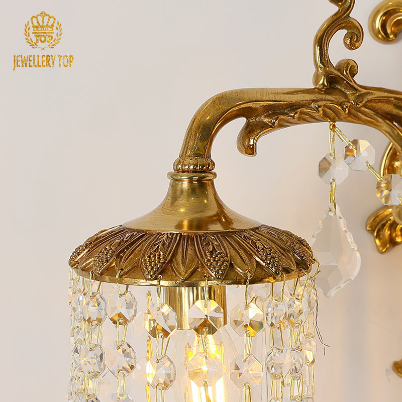 Gently curved arms leading to metal tops, each draped in sparkling crystal strands