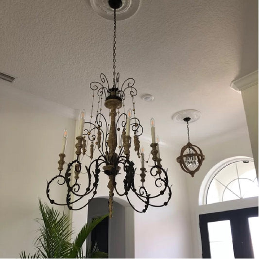 Hand-carved lavender motif on reclaimed wood column of country chandelier