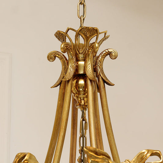 Close-up of baroque-inspired botanical motifs on a regal chandelier frame.