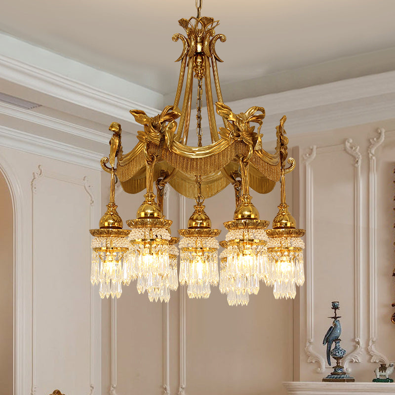 Suspended crystal droplets glistening under candle-style bulbs on a Victorian chandelier.