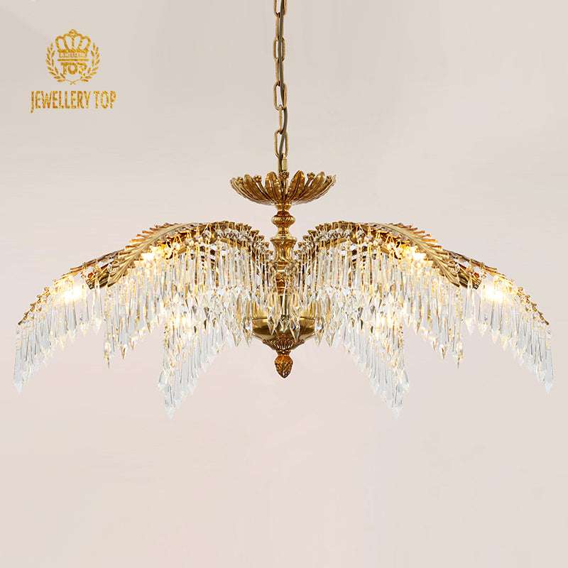 Elegant palm leaf chandelier with crystal pendants and a brass frame.