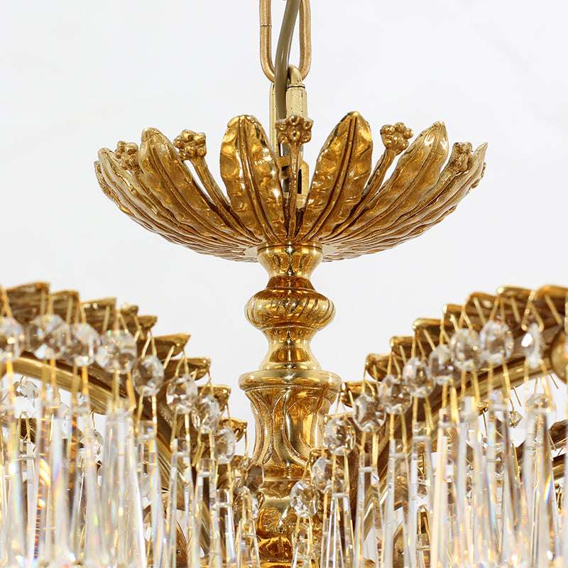 Close-up of brass palm fronds and sparkling crystals on the tropical chandelier.