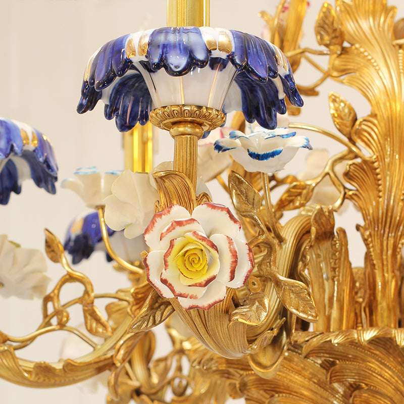 Elegant floral chandelier featuring warm brass and delicate ceramic details