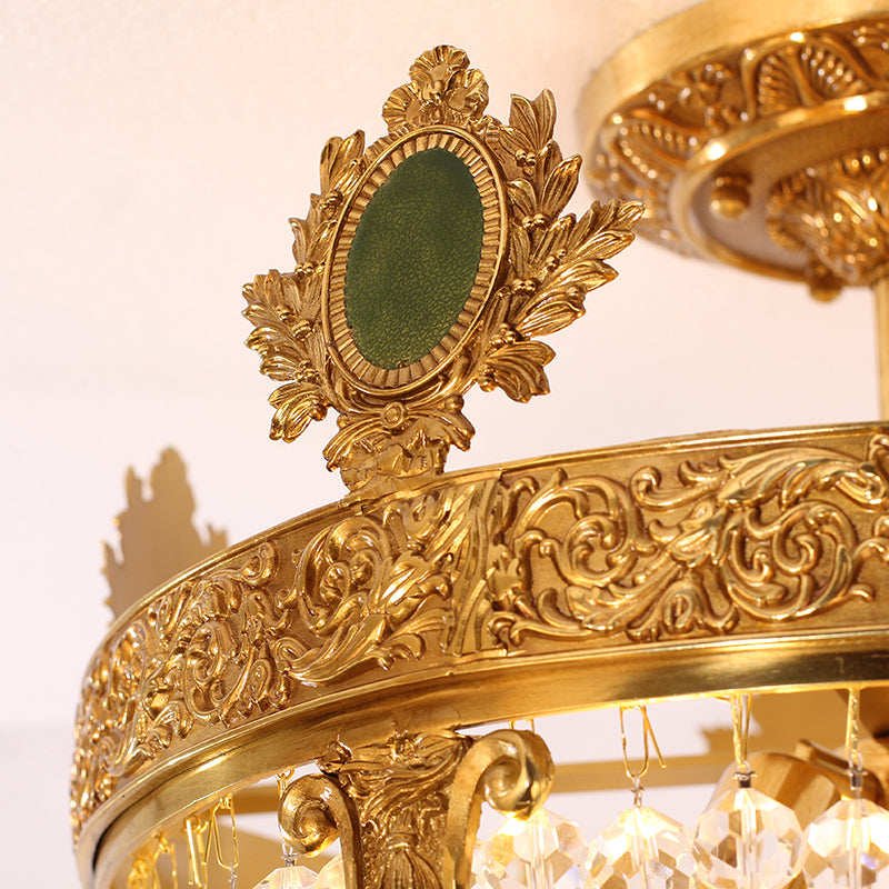 Close-up of floral crown detailing and crystal strands on antique ceiling light.