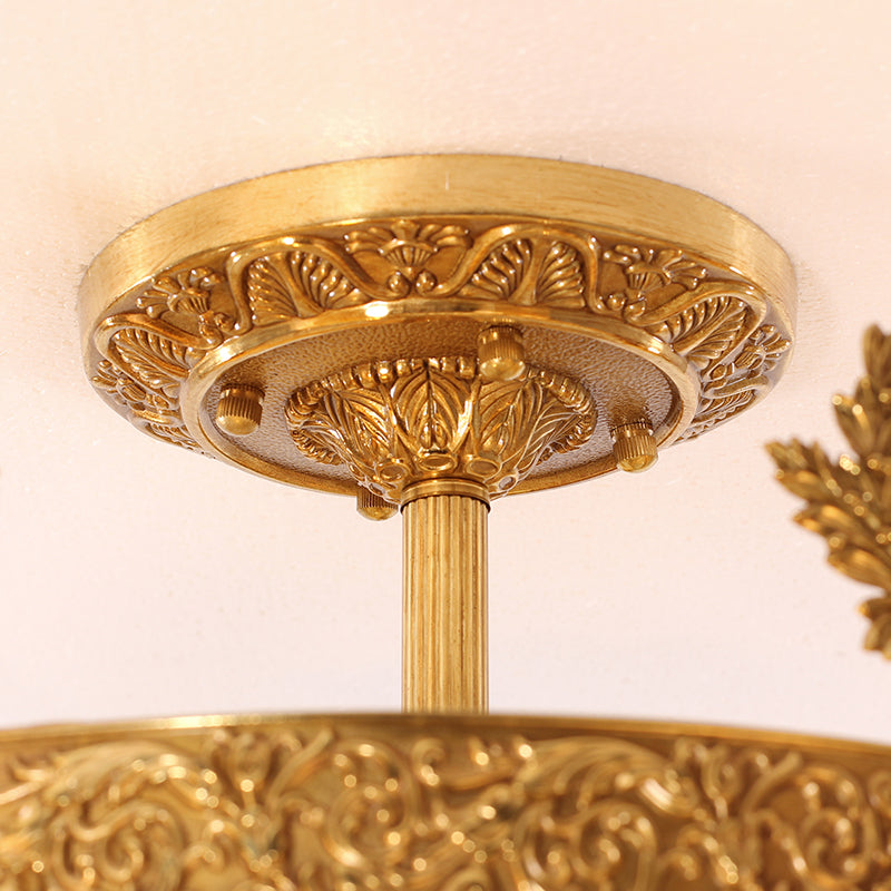 Decorative medallion motif on brass frame of classic flush mount fixture.