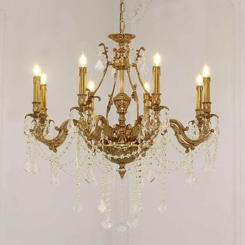 Elegant crystal strands cascading gracefully from an antique-style brass chandelier.