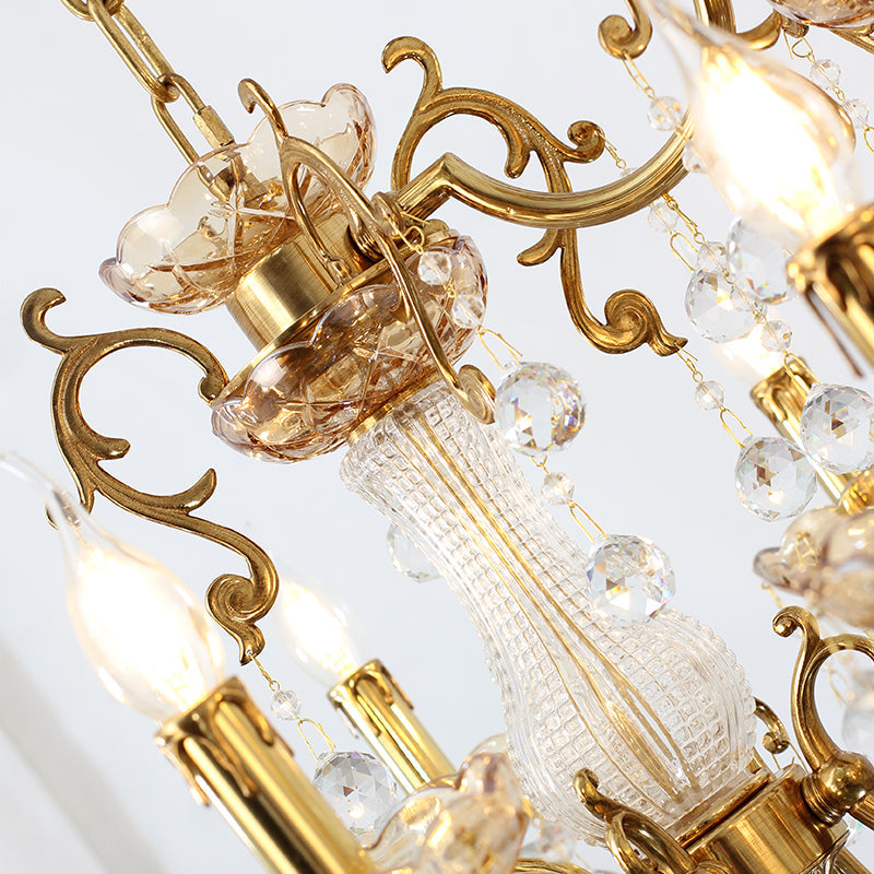 Close‑up of ornate brass scrollwork and crystal accents on dining chandelier.
