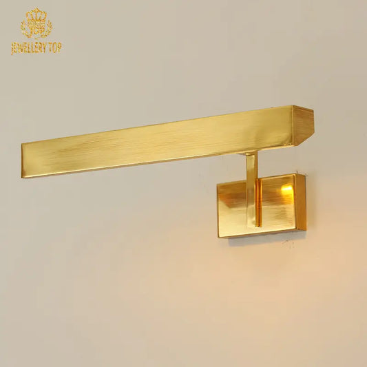 Helios' brass wall sconce illuminating neutral wall