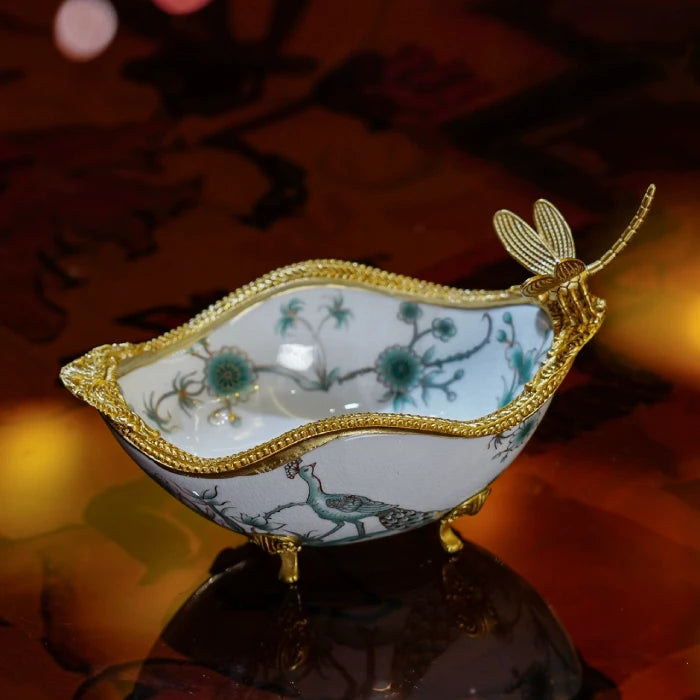 Close-up of lunar moth and night-blooming floral patterns on white ceramic decorative dish