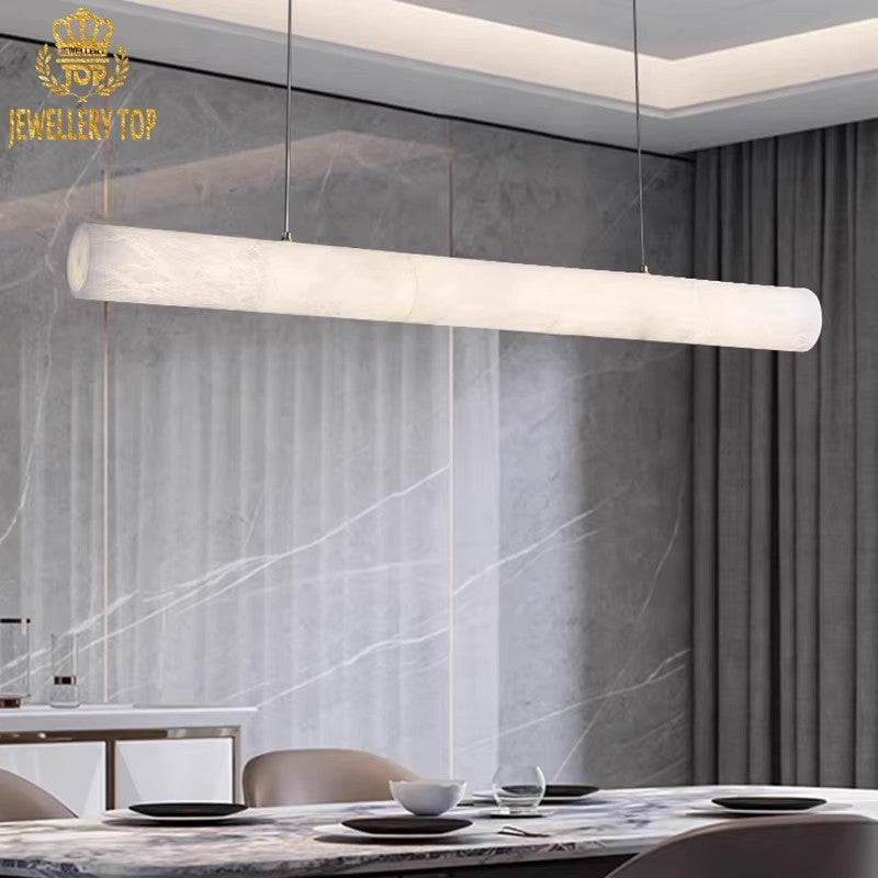 Nebula Beam Alabaster Linear Pendant Lamp suspended above a dining table