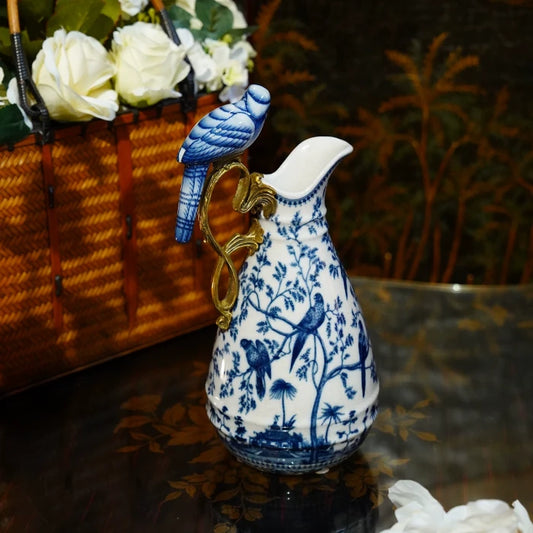 Close-up of blue and white porcelain decorative vase with tree and bird motifs