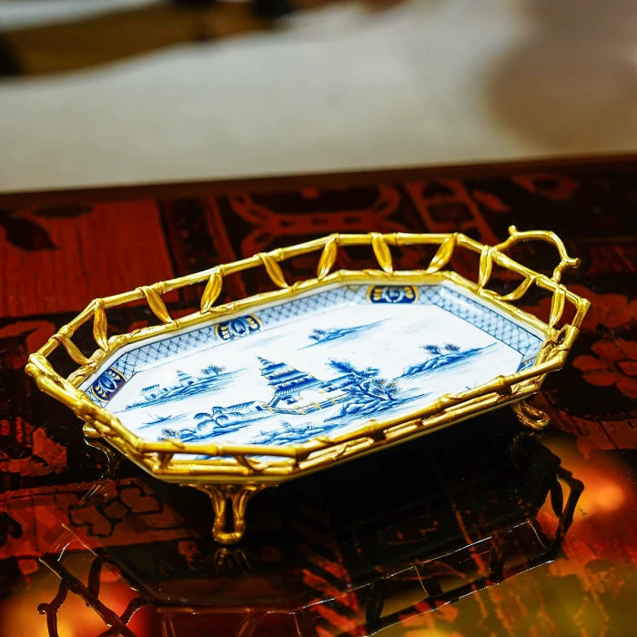 Close-up of blue and white ceramic decorative tray with pagoda, trees, and mountainous landscape
