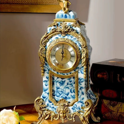 Detailed close-up of a brass muse bust and ornate Rococo scrollwork on a blue-and-white ceramic table clock.