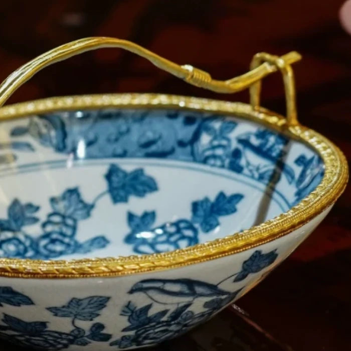 Full view of oval candy dish featuring brass handle and spring-inspired designs