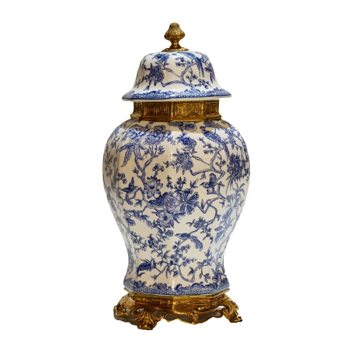 Full front view of decorative ceramic jar with blue bird and peony motifs, brass band, and dome lid.