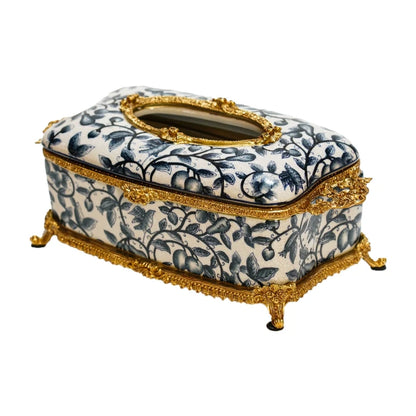 Blue and white floral ceramic tissue box with ornate brass framing and oval aperture