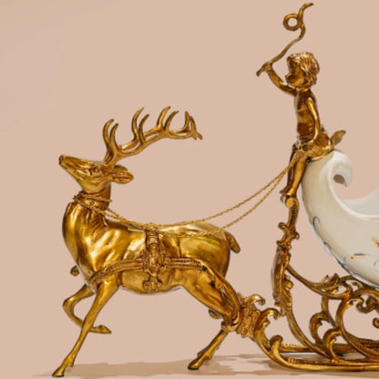 Close-up of ceramic chariot adorned with swallows and lilies on white background