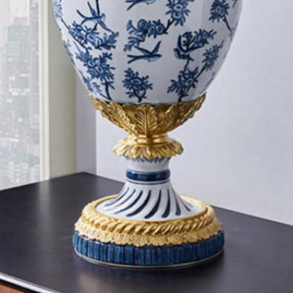 Detailed view of brass cherub handle and ram’s head ornament on decorative vase